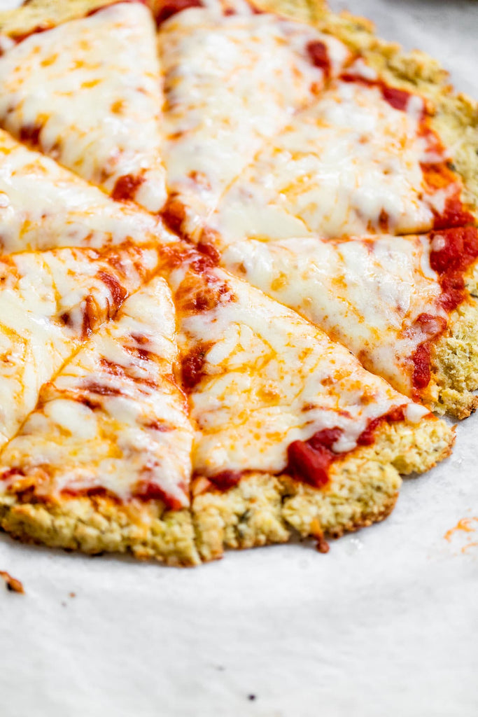 Cauliflower Pizza Crust is what gluten free pizza dreams are made of! It's made with cauliflower rice, almond flour and egg, and it's crispy on the outside and actually holds together