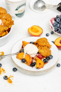 Fresh juicy peaches, and sweet seasonal berries topped with cake-like “golden milk” biscuits