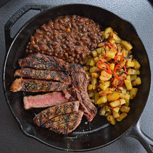 Cowboy Ribeye Steak with Crispy Potatoes and Black Beans